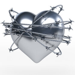 A silver heart with barbed wire wrapped around it. 