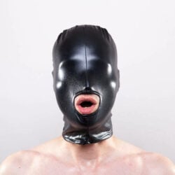 A person wearing a leather hooded mask with only their naked chest and an open mouth visible.