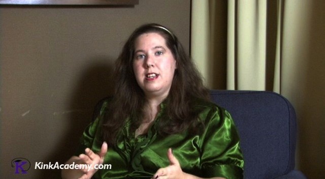 Woman sitting in a chair talking into the camera.