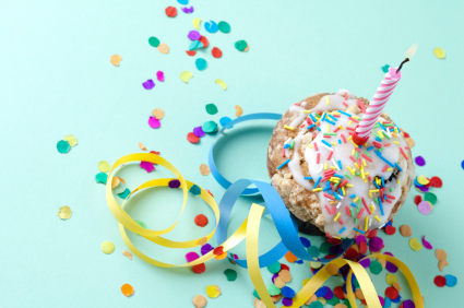 A cupcake with sprinkles and streamers