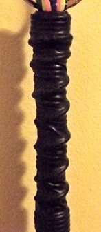 A long black gimp flogger with ribbing