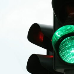The green light at a stop light is illuminated