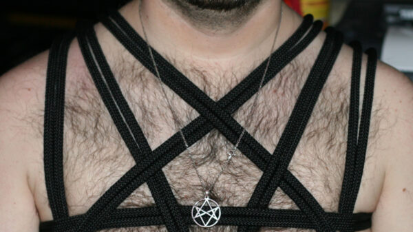 Pentagram straps and necklace on a chest