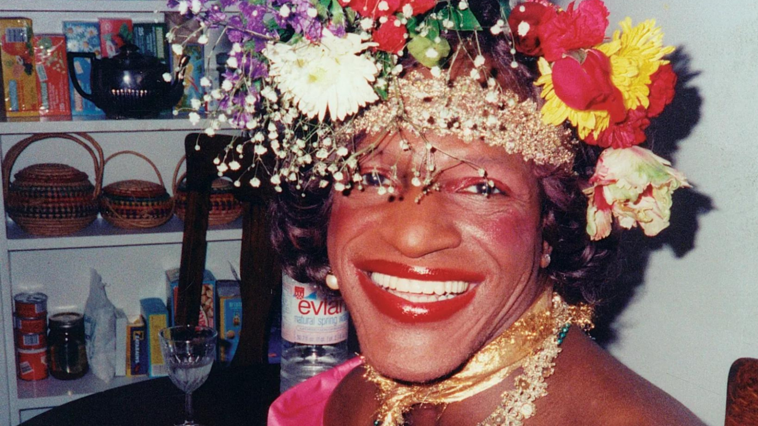 A photo of Marsha P. Johnson wearing a flower crown